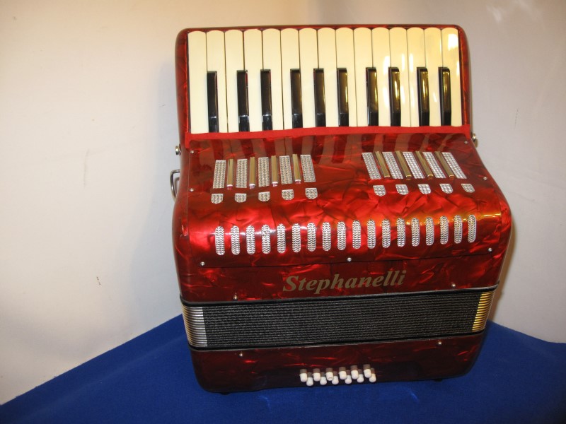 New red stephanelli accordion with 26 treble keys and 12 bass